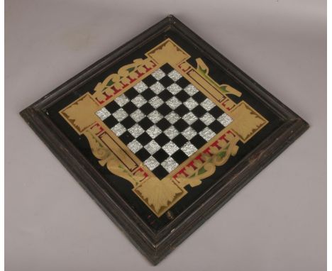 A vintage chess board, with gilt and foil decoration. (48cm x 48cm).  
