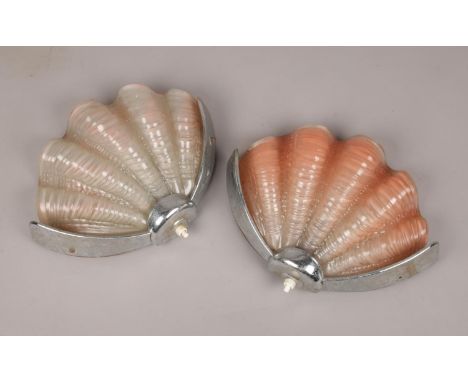 A pair of glass and chrome Art Deco shell wall lights.  Nibbles to edge of glass shades. Metal brackets missing to one light.