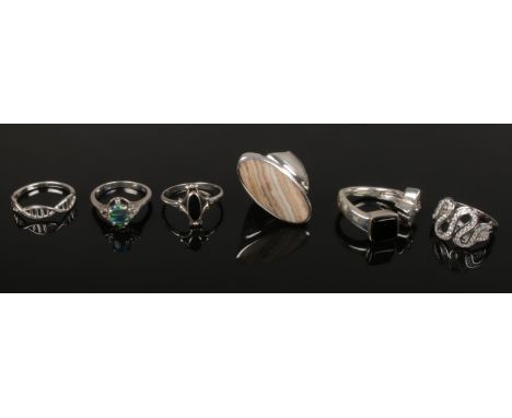 Six silver dress rings. One set with a black opal effect stone.  