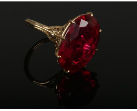 A vintage 9ct gold cocktail ring set with a large ovoid red stone. Assayed London 1968. Size N.  