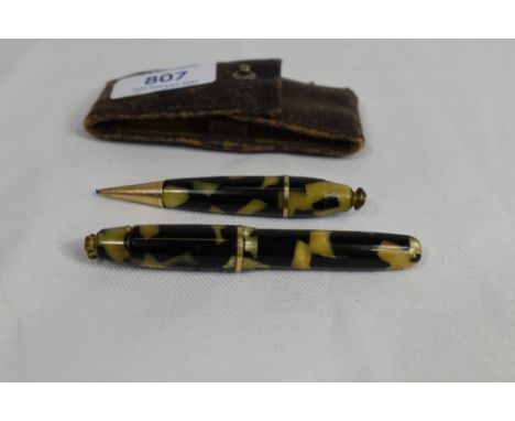 An unnamed lever fill fountain pen and pencil set in pearl and black, of small proportions in folding leather case