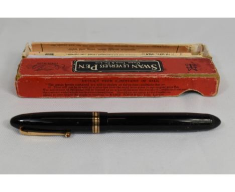 A boxed Mabie Todd Swan 4460 twist fill fountain pen in black with a broad and two narrow bands to the cap having a Swan 14ct