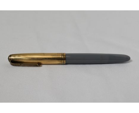 A Parker 51 button fountain pen in grey with gold filled cap with blue diamond to the clip. In good condition some light ding