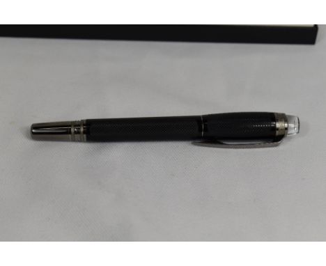 A Monteblanc FL Starwalker rollerball in black. As new in original box with service book and guarantee certificate