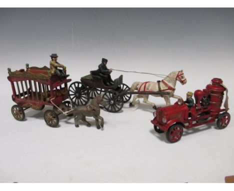 Three painted cast iron wheeled models (reproductions), fire engine, circus and wagon and rider  
