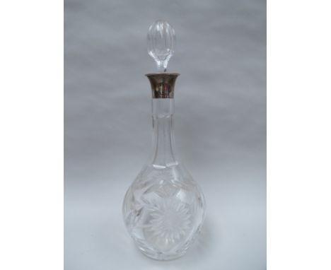 A John Grinsell & Sons cut crystal decanter with stopper and silver collar, Birmingham 1932, approximately 33cm tall