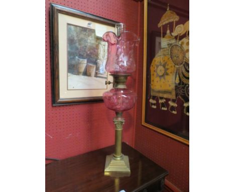 An etched cranberry oil lamp on column base to stepped square base 