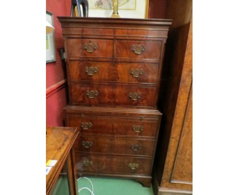A George III revival flame mahogany chest on chest, two over five long drawers and brushing slide on bracket feet