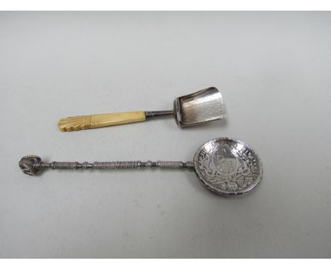 A silver caddy spoon with ivory handle, Birmingham 1840 and a coin spoon with Rams head terminal (2) 