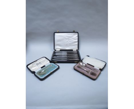 A selection of cased flatware including silver handled butter knives, Christening feeding set and miniature forks (3)