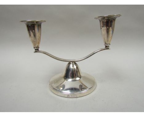 An Elkington & Co., silver twin sconce candlestick, Birmingham 1966, weighted base