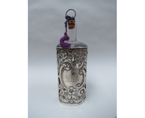 A silver and glass scent bottle heavily pierced, monogramed, Birmingham 1898 by Arthur Willmore Pennington, 17cm tall