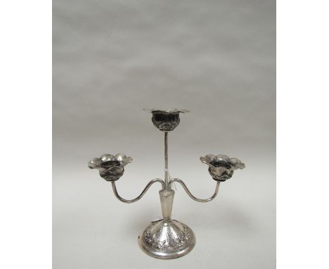 A white metal three sconce candlestick of floral form, weighted base, 16cm tall