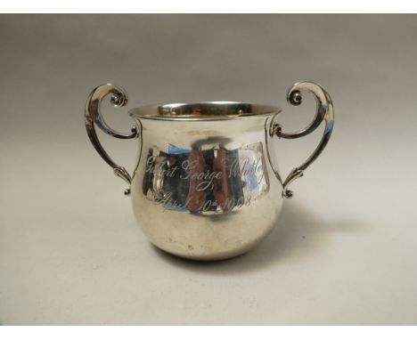 A James Dixon and Sons silver twin handled cup, scroll handles, engraved Gilbert George, Whitley, April 10th 1908, Sheffield 