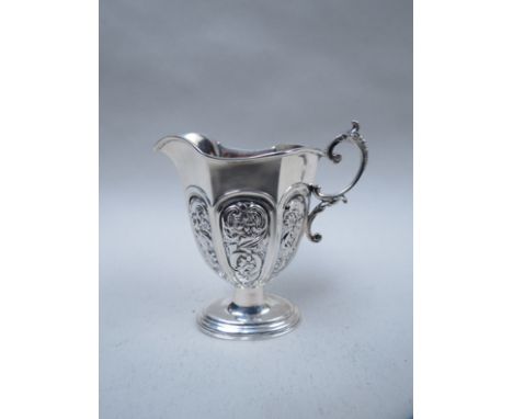 A silver cream jug with embossed panels, s-scroll handle, marks rubbed, Birmingham, 57g