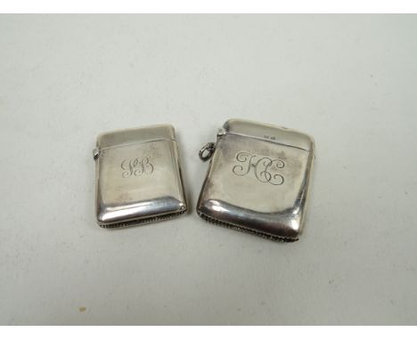 A silver vesta case, monogrammed, and lighter