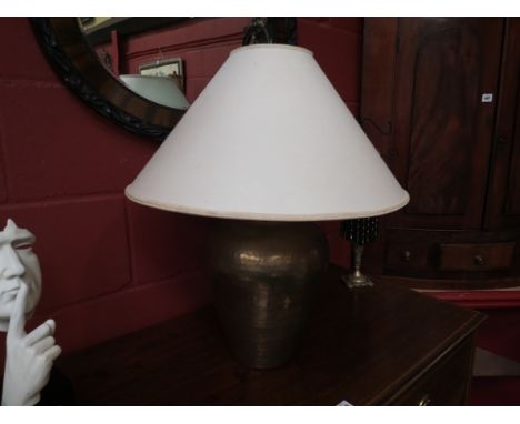 A large hammered brass table lamp with cream shade 