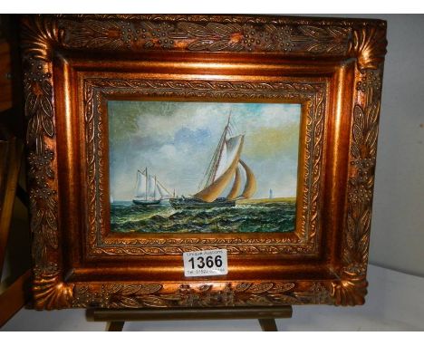 A gilt framed seascape featuring yachts, 30 x 25 cm.
