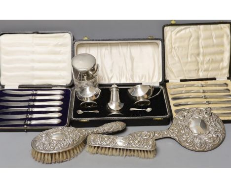 A cased 1950's silver three piece condiment set, two cased sets of six silver handled tea knives, a silver mounted glass salt