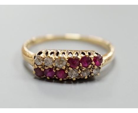 An 18ct, ruby and diamond set two row ring, size P/Q, gross 3.1 grams.