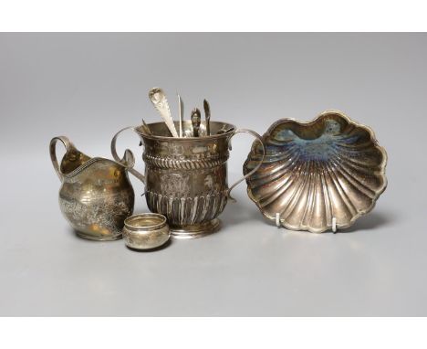 A George II silver porringer, London, 1748, 10.9cm, a George III silver cream jug, a silver shell dish, pair of silver tub sa