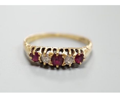 An 18ct three stone ruby and two stone diamond set half hoop ring, size P, gross 2.9 grams.