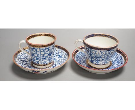 A Worcester coffee cup and saucer of rare Sevres shape with entwined handle painted with the Royal Lily pattern with an unusu