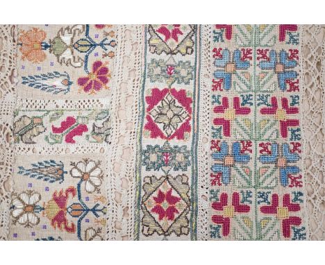 A 19th century Greek Islands polychrome silk embroidered runner on cram linen, with silk and linen bobbin lace insertions and