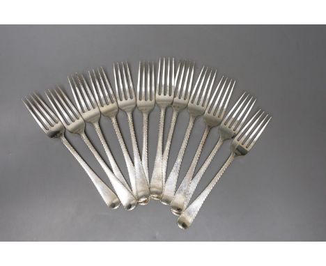 A set of twelve late George III silver Old English feather edge pattern table forks, indistinct maker's mark, London, 1818/19