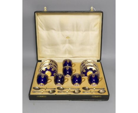 Boxed Royal Worcester blue coffee set with gilt stylised shell and swag design together with six silver coffee spoons; C899 a