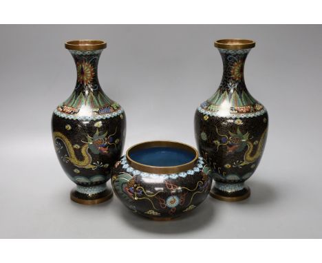 A pair of early 20th century Chinese cloisonne enamel 'dragon' vases and a matching bowl