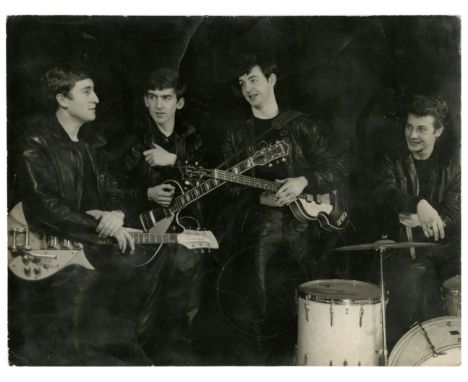 An original sixties black and white photograph of The Beatles taken at the photographic studio of Albert Marrion in Wallasey,