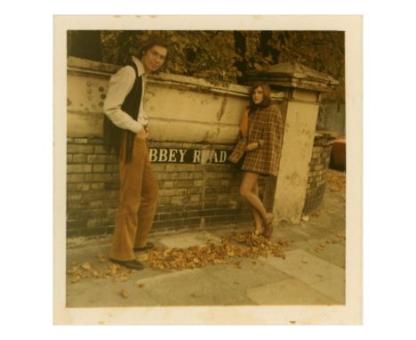 An original sixties colour photograph of two people stood in front of the Abbey Road street sign which was featured on the ba