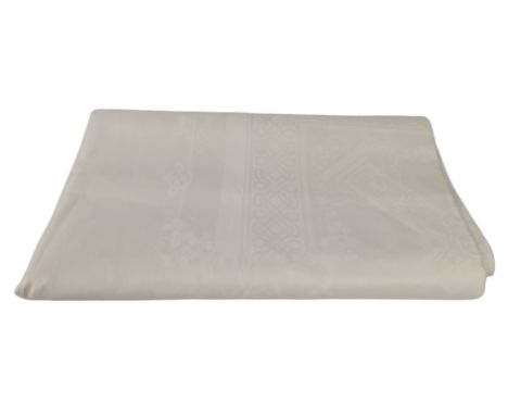 A large white linen tablecloth with floral design that previously belonged to Freddie Mercury. Provenance: previously sold as