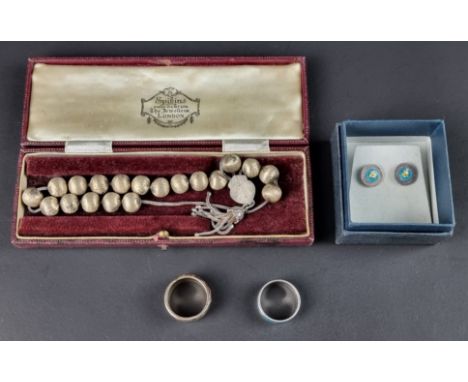 A white and yellow metal ring, decorated with blue enamel, stamped 925 and 22k; together with a matching pair of ear studs; a