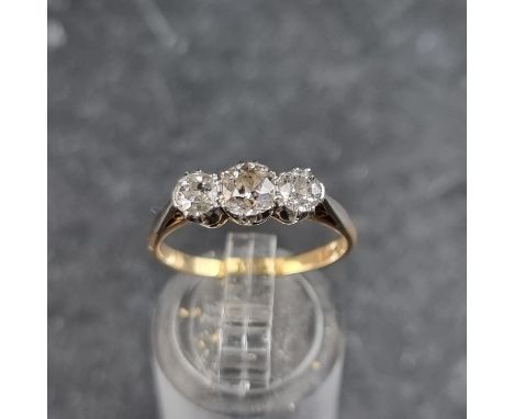 A yellow metal diamond three stone ring, stamped 18ct, size O 1/2.