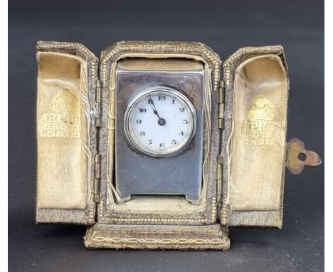 A cased silver mounted clock, by F A W, London 1919, 4cm high, having a Swiss manual wind movement, with key.