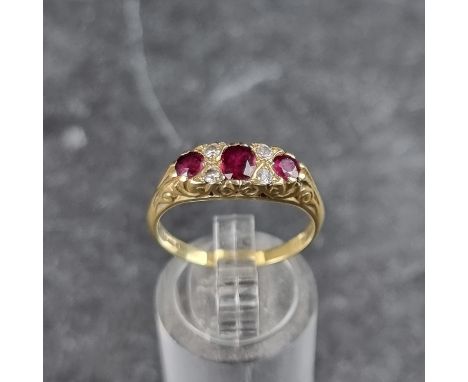 An 18ct gold ruby and diamond seven stone ring, London 1981, size P, gross weight 3.8g.