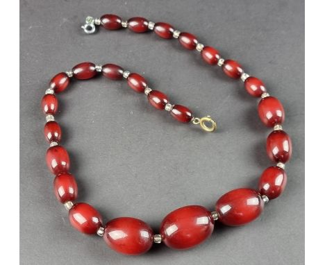 A vintage cherry amber style graduated bead necklace, having twenty four beads interspersed with clear glass beads, graduated