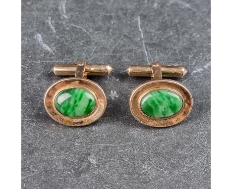 A pair of yellow metal cufflinks,&nbsp;set cabochon jade panels, stamped W K and 14k, each panel 20 x 16mm.