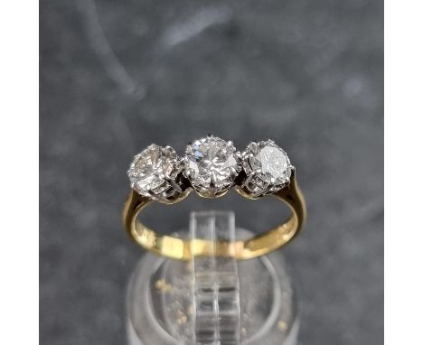 A diamond three stone ring, the brilliant cut diamonds of approximately 1ct in total, stamped 18ct, size M.