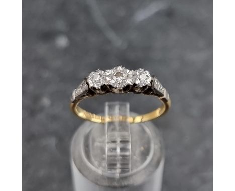 An 18ct gold illusion set diamond three stone ring, Birmingham 1963, size N 1/2, gross weight 2.5g.