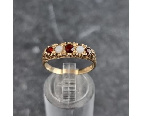 A 9ct gold garnet and opal five stone ring, size O, London 1979, gross weight 2.5g.