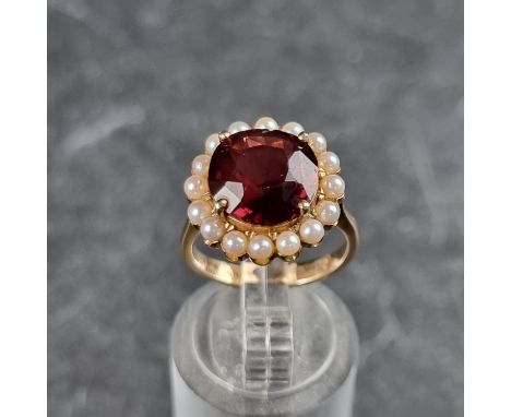 A garnet and pearl cluster ring, stamped 14k, size I.