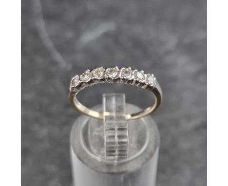 A yellow metal diamond seven stone ring, stamped 750, size L.