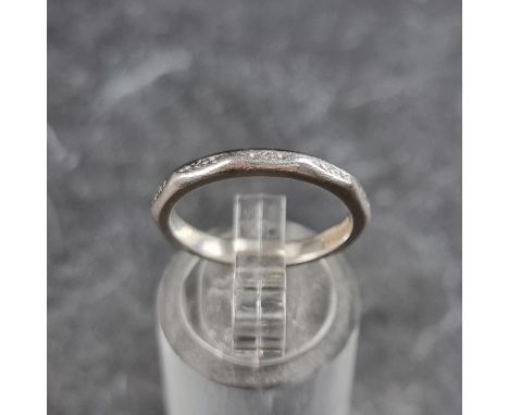 A platinum wedding band, stamped 'Century Platinum', size K.