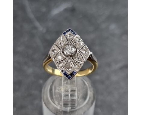 An Art Deco diamond and sapphire rhombus shaped panel ring, set thirteen variously cut diamonds and ten square sapphires, siz