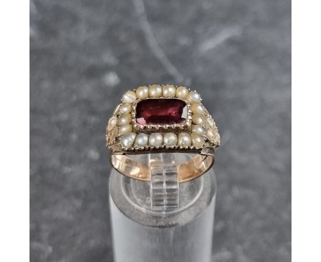 An early 19th century yellow metal amethyst and split pearl ring, size J.