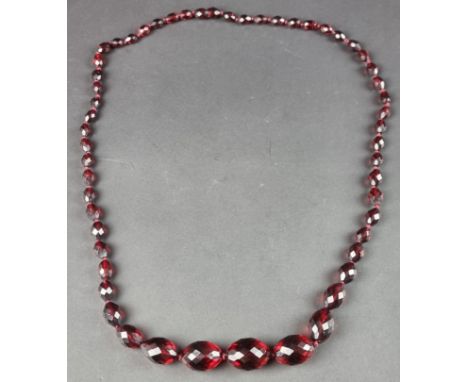 A vintage cherry amber style graduated faceted bead necklace, containing 53 beads graduated from 24mm to 8mm in length, 66cm 