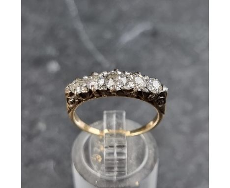 A yellow metal ring, set five graduated old cut diamonds and ten small diamond chips, stamped 18ct, size P.